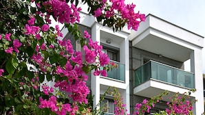 A modern building with balconies and a staircase. - Royal Palm Residence (Bodrum)