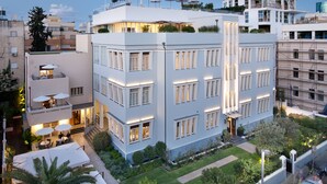 A multi-story hotel with balconies, outdoor seating, and a well-maintained garden. - The Norman Tel Aviv (Tel Aviv)