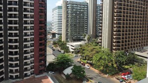 A high-rise building complex with multiple floors, balconies, and a central plaza area.