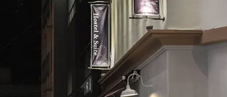 A hotel sign with the text "Hostel & Suite" indicating accommodation options.