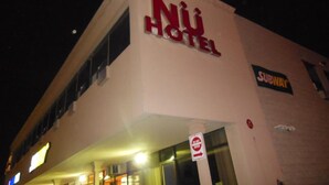 A hotel with a sign reading "NÜ HOTEL" and a Subway sign on the side. - Nu Hotel Toronto (Mississauga)