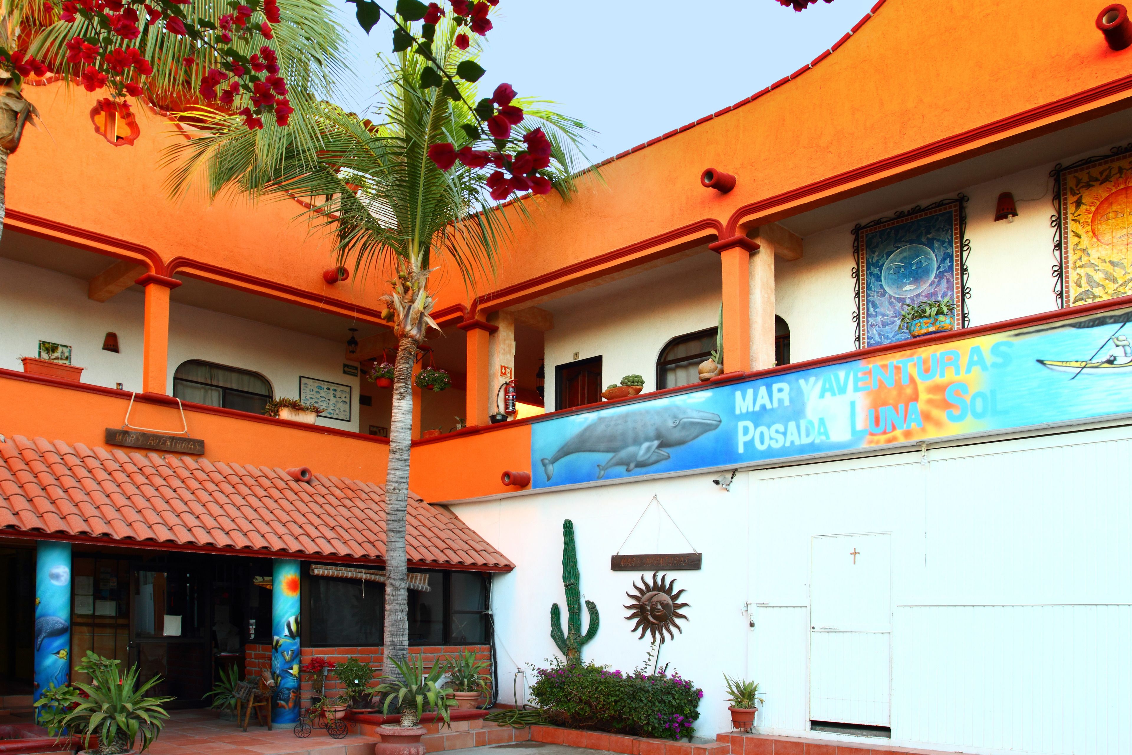 A building with a mural of a whale and the text "MAR YAVENTURA POSADA LUNA SOL".