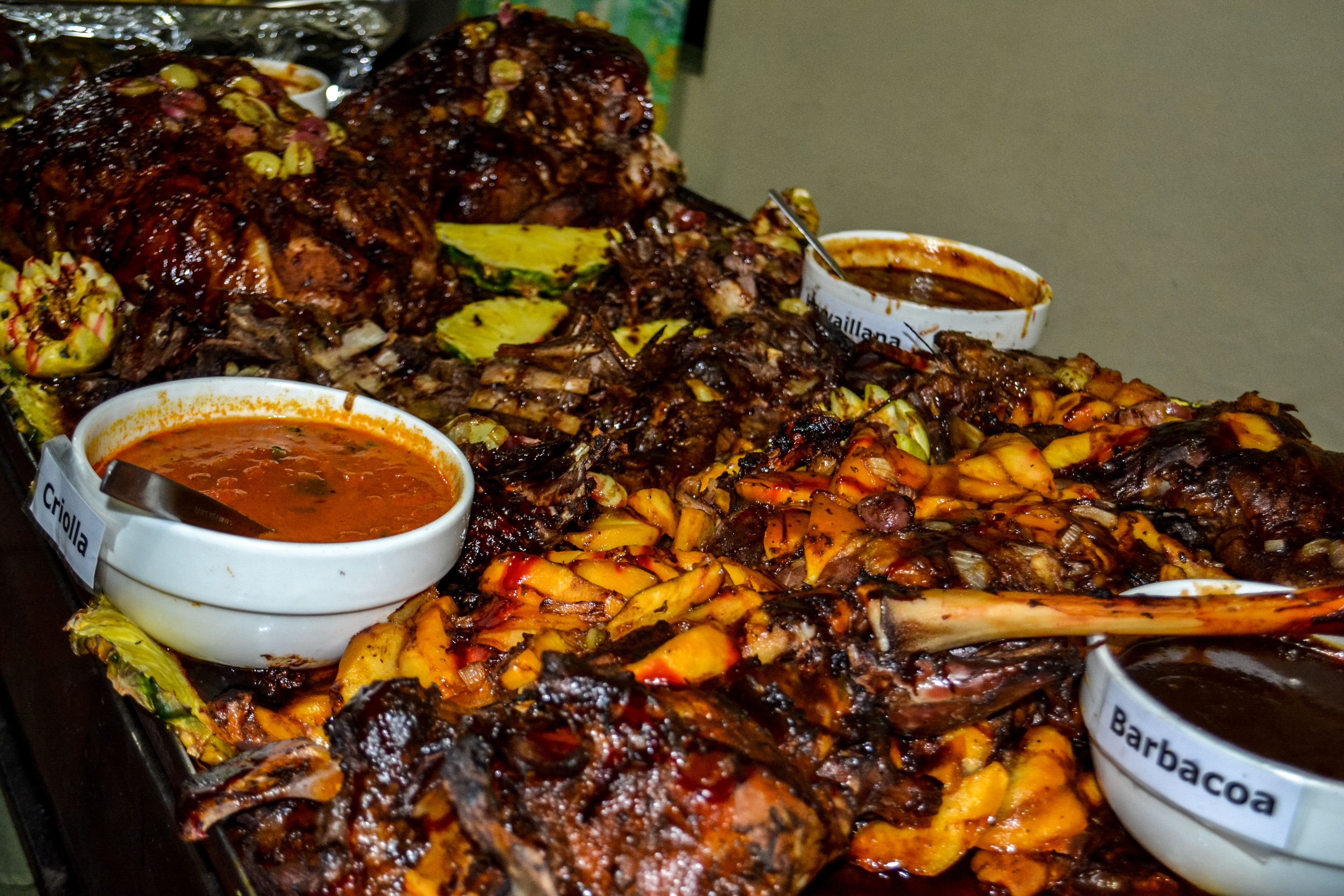 A buffet table with various dishes including roasted meats and sides.