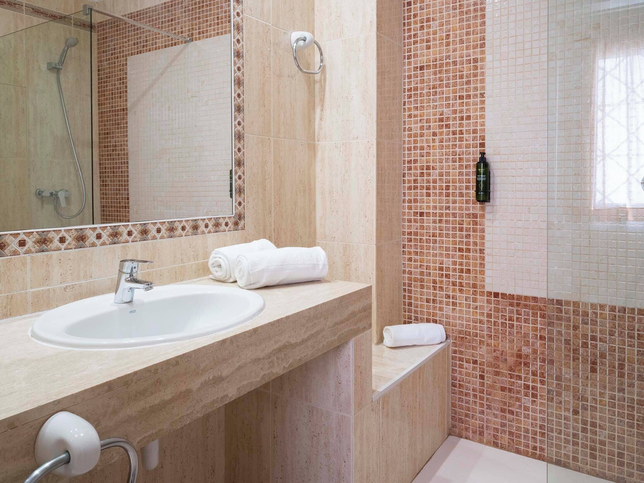 Shower, designer toiletries, hair dryer, bidet