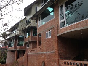 A multi-story building under construction with exposed brickwork and unfinished windows. - Feng Ya Yue Zhu (Guanxi)