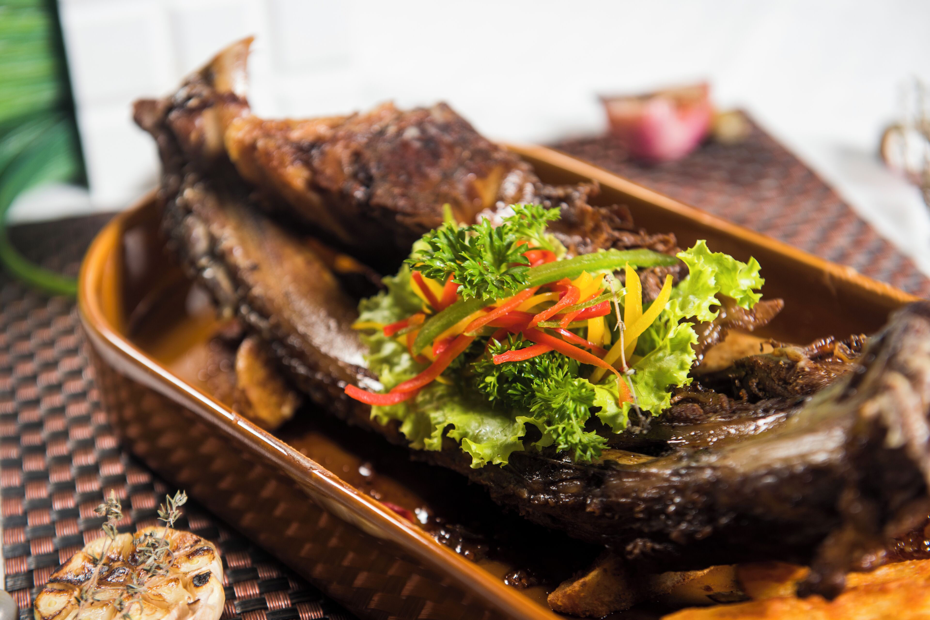 A roasted duck with vegetables on a plate.