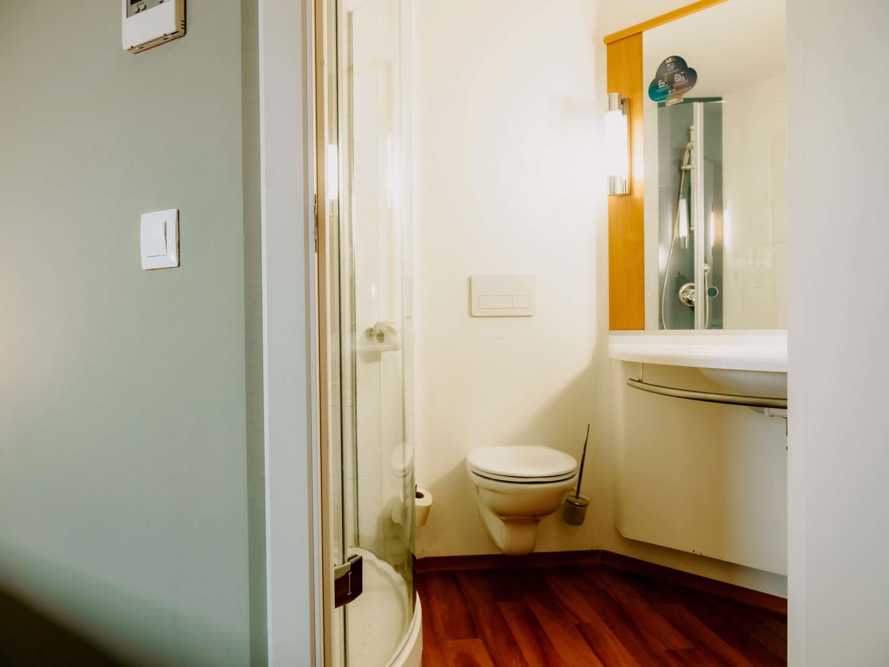 Un baño con inodoro, bidé y ducha.