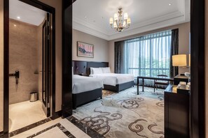 A hotel room with two beds, a chandelier, a large window with curtains, a desk with a lamp, and a painting on the wall. - Wyndham Grand Xian South (Xi'an)