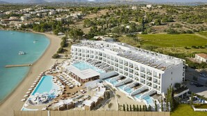 A resort with multiple swimming pools, a beach, and a view of the surrounding landscape. - Nikki Beach Resort & Spa Porto Heli (Ermionida)