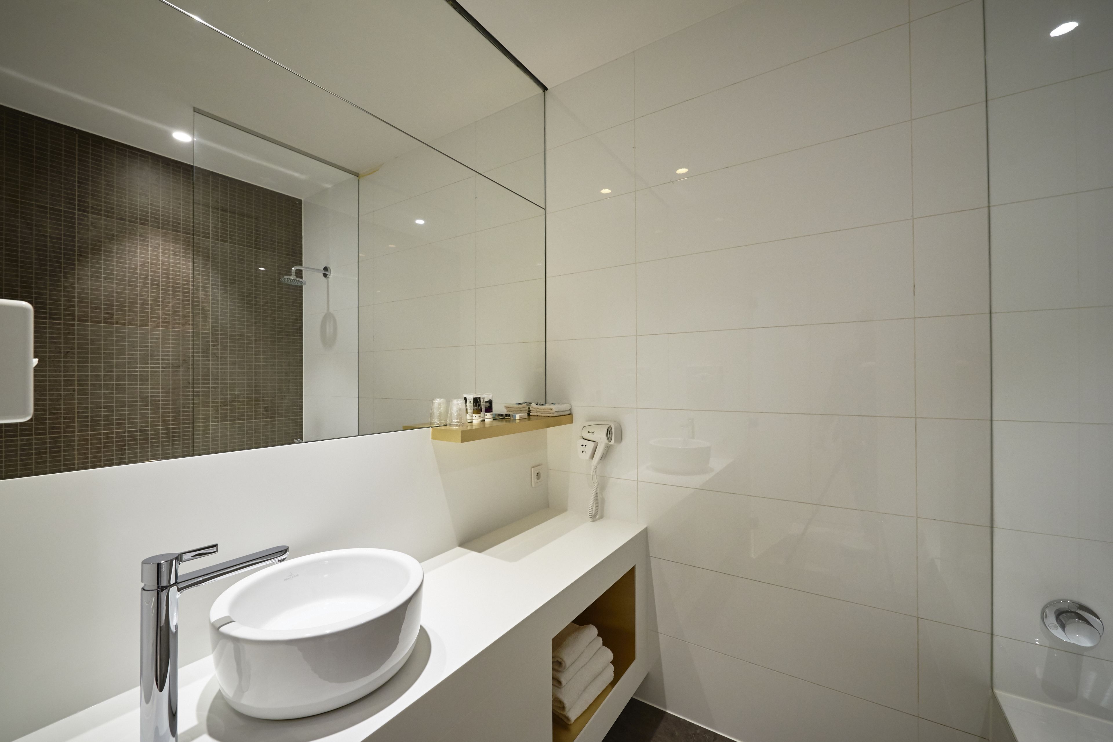 rainfall showerhead, eco-friendly toiletries, hair dryer, towels