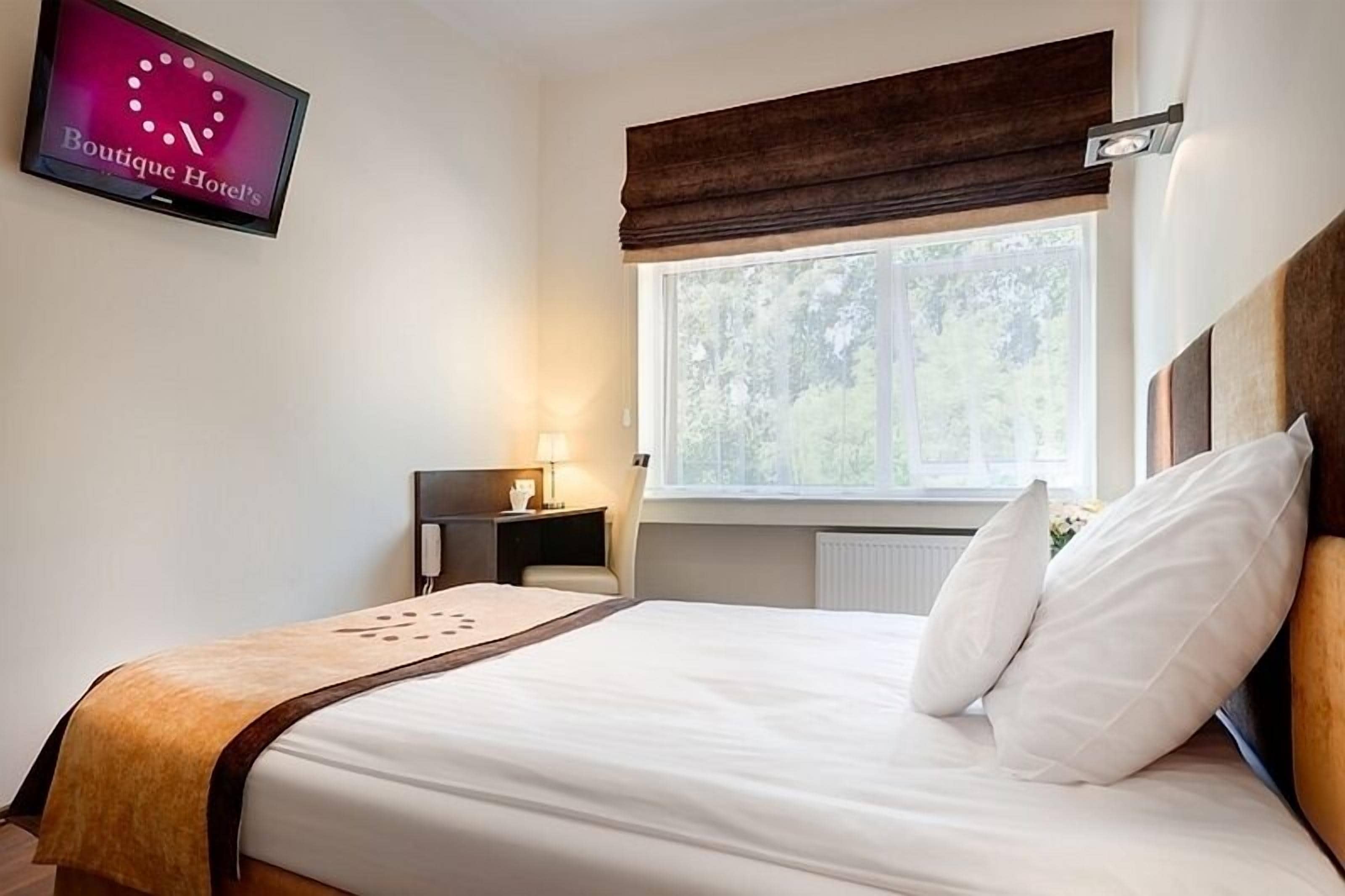 premium bedding, desk, blackout curtains, iron/ironing board