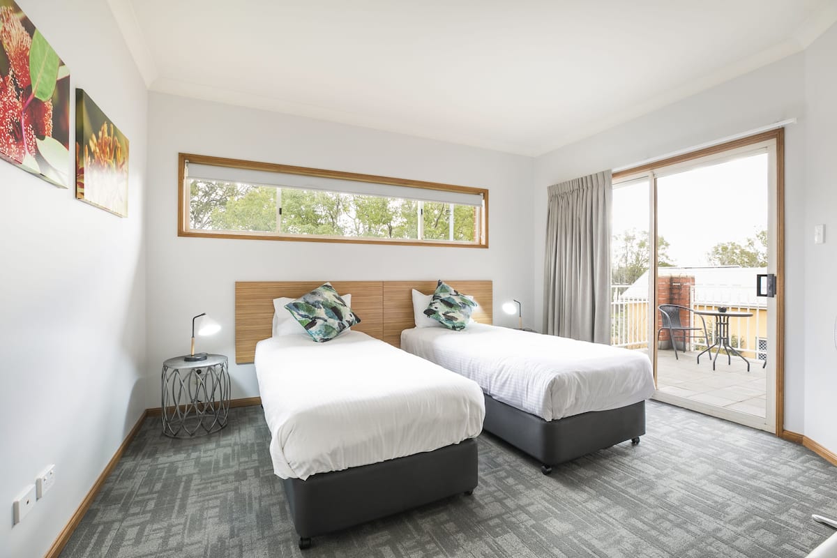 three bedroom apartment | 1 bedroom, desk, laptop workspace, iron/ironing board