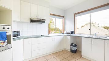 Three Bedroom Apartment | Private kitchen | Mini-fridge, electric kettle