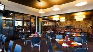 A spacious restaurant with high ceilings, multiple dining tables, and modern pendant lighting. - Nightcap at Federal Hotel Toowoomba (East Toowoomba)
