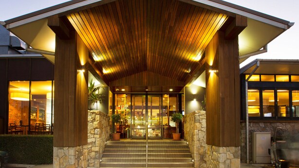 A building with a wooden roof and stone walls, featuring a staircase leading to the entrance. - Nightcap at Federal Hotel Toowoomba (East Toowoomba)