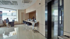 A modern office space with a reception desk, computers, and a glass partition. - Mandarin Hotel (Kota Kinabalu)