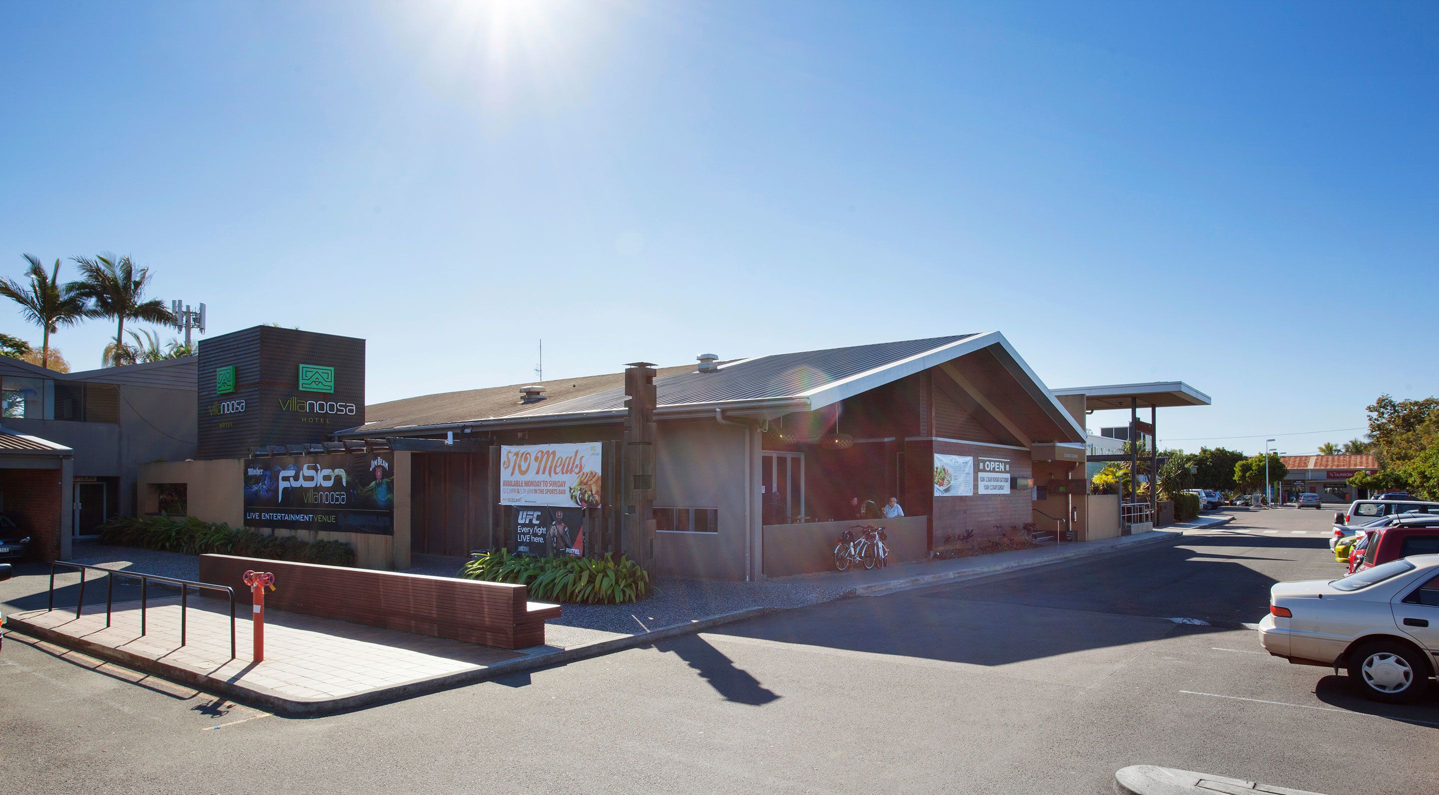 A hotel with a modern design, featuring a prominent sign for the Villanoosa Hotel.