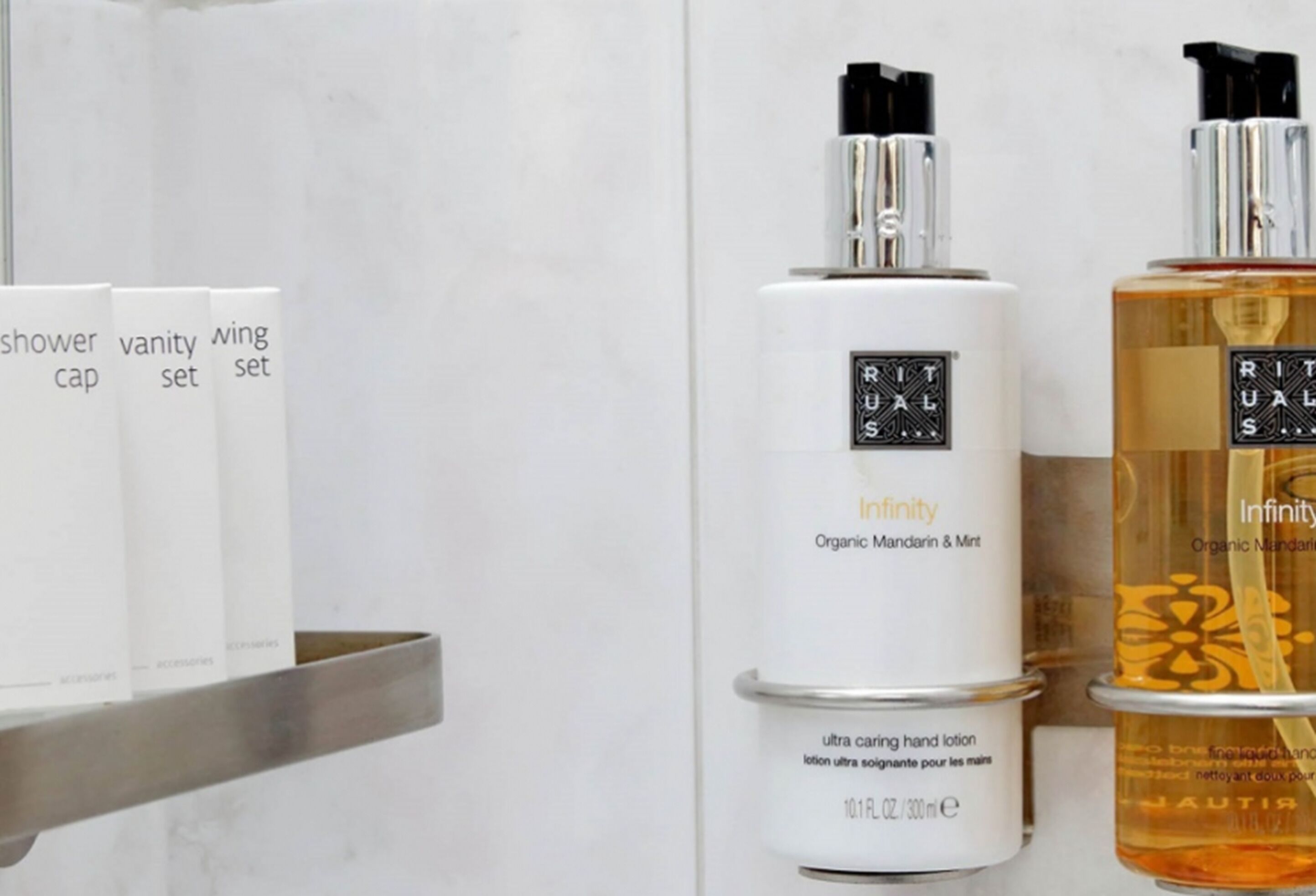 A bathroom shelf with various toiletries including a shower cap, vanity set, and wing set.