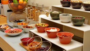 A buffet with various food items and containers. - Casa Santa Sofia Hotel (Rome)