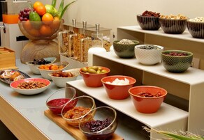 A buffet with various food items and containers.