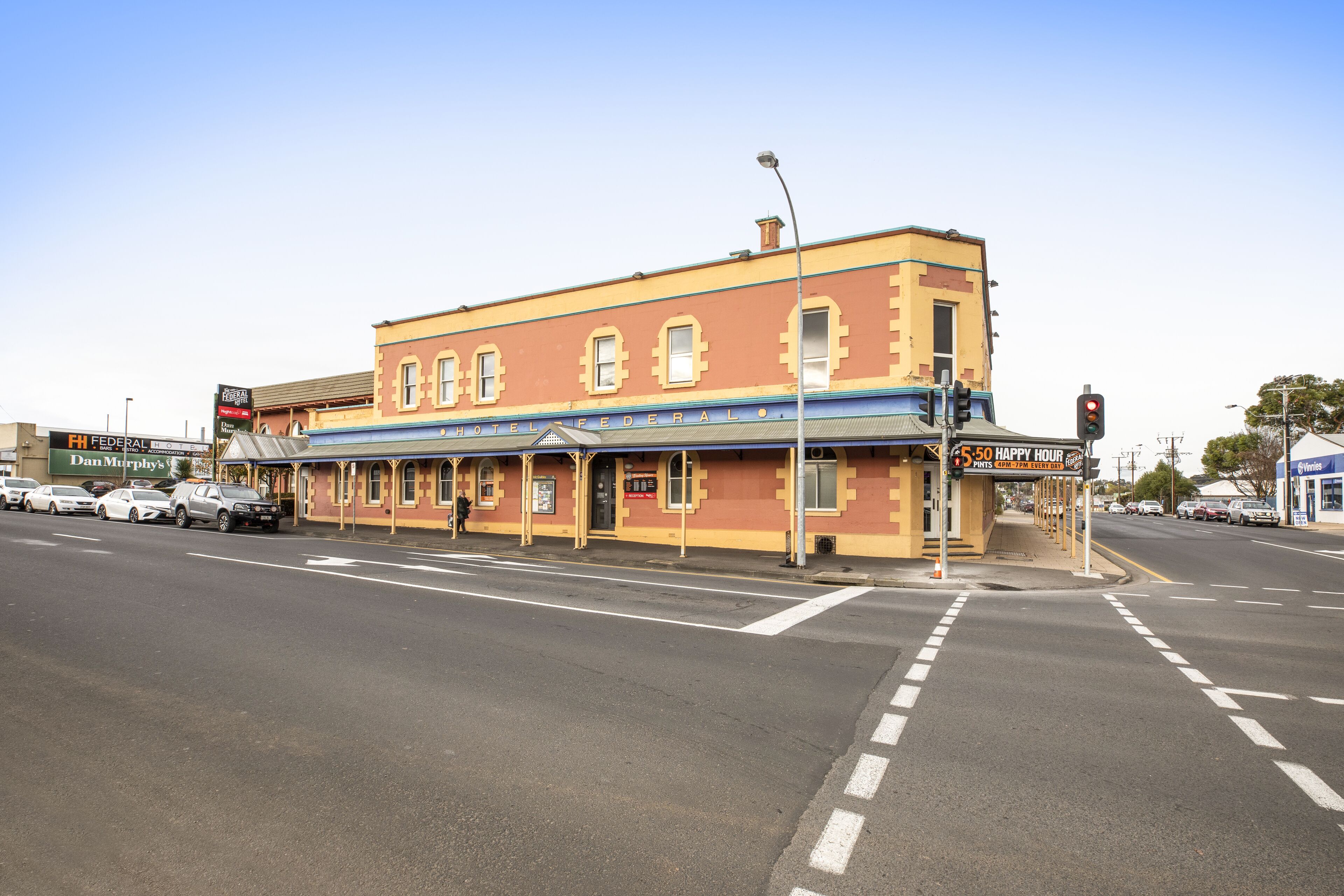 A two-story building with a yellow facade and a sign that reads "HOTEL FEDERAL."
