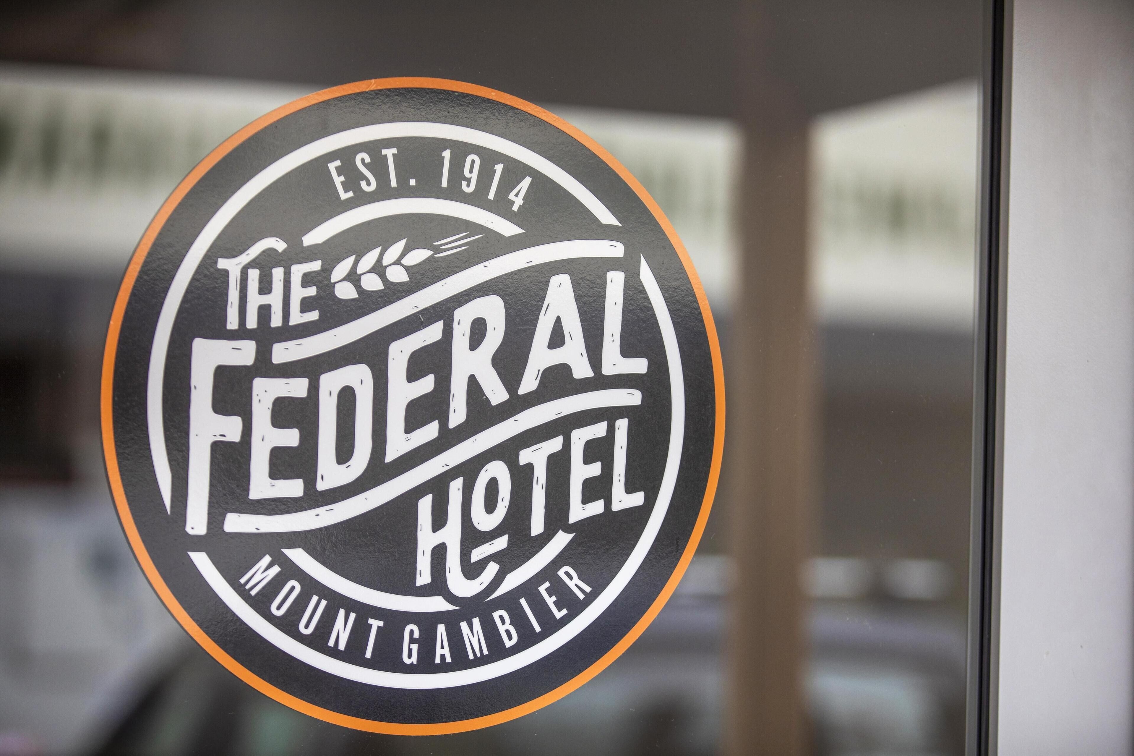 A circular sign with the text "The Federal Hotel Mount Gambier" and "Est. 1914" indicating the hotel's name and establishment year.