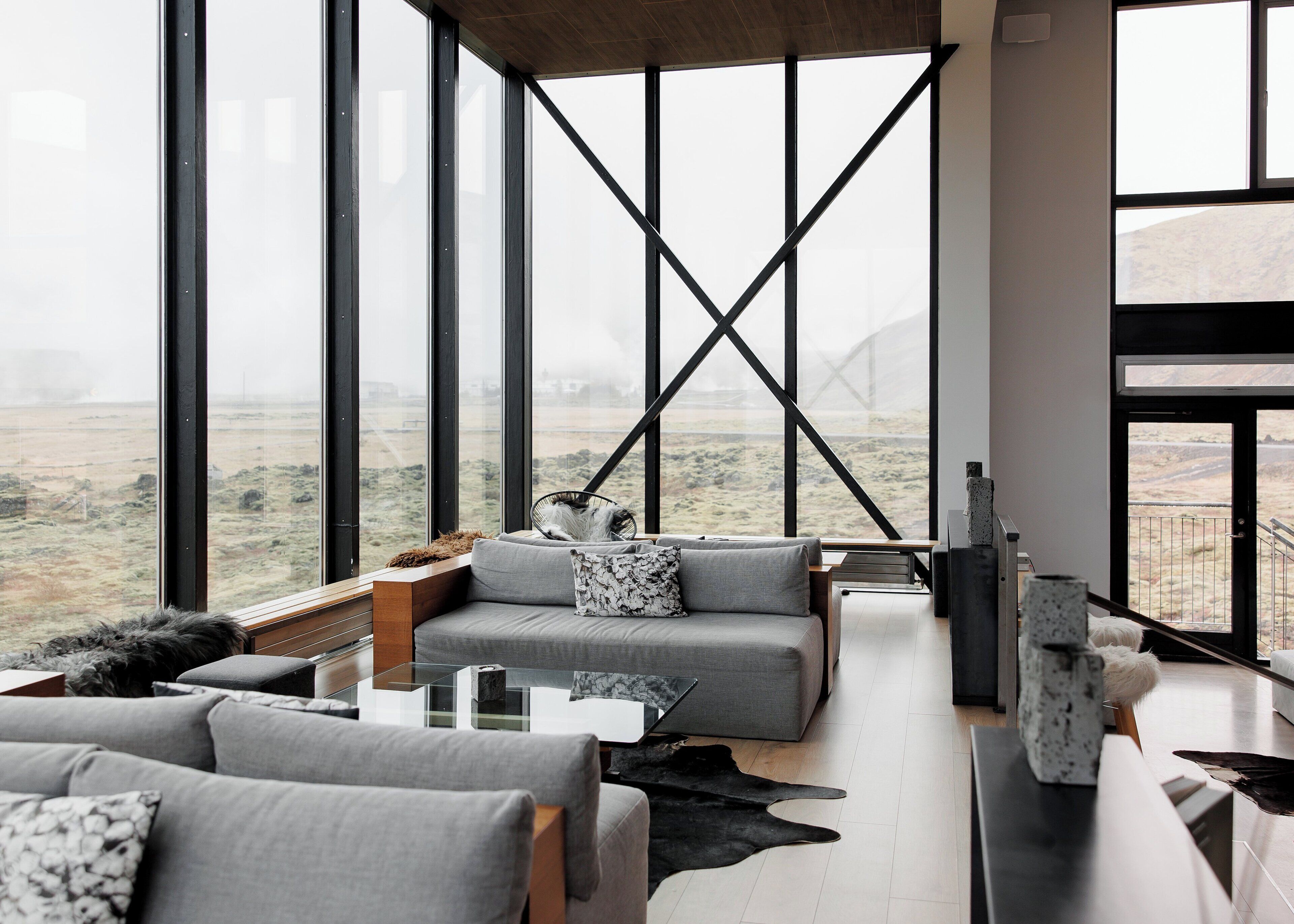 A spacious living area with a large window overlooking a barren landscape.