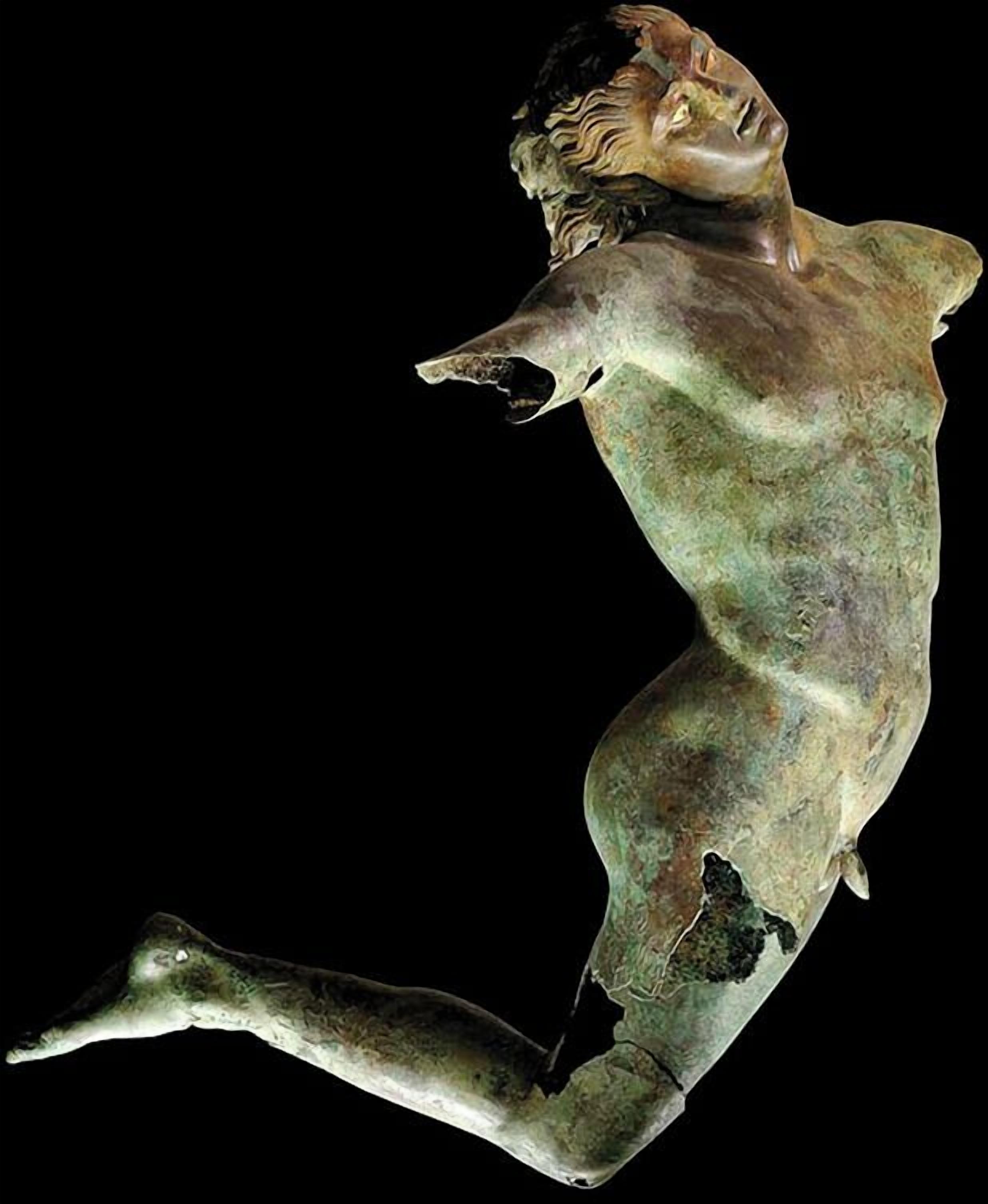 A sculpture of a human figure in a dynamic pose.