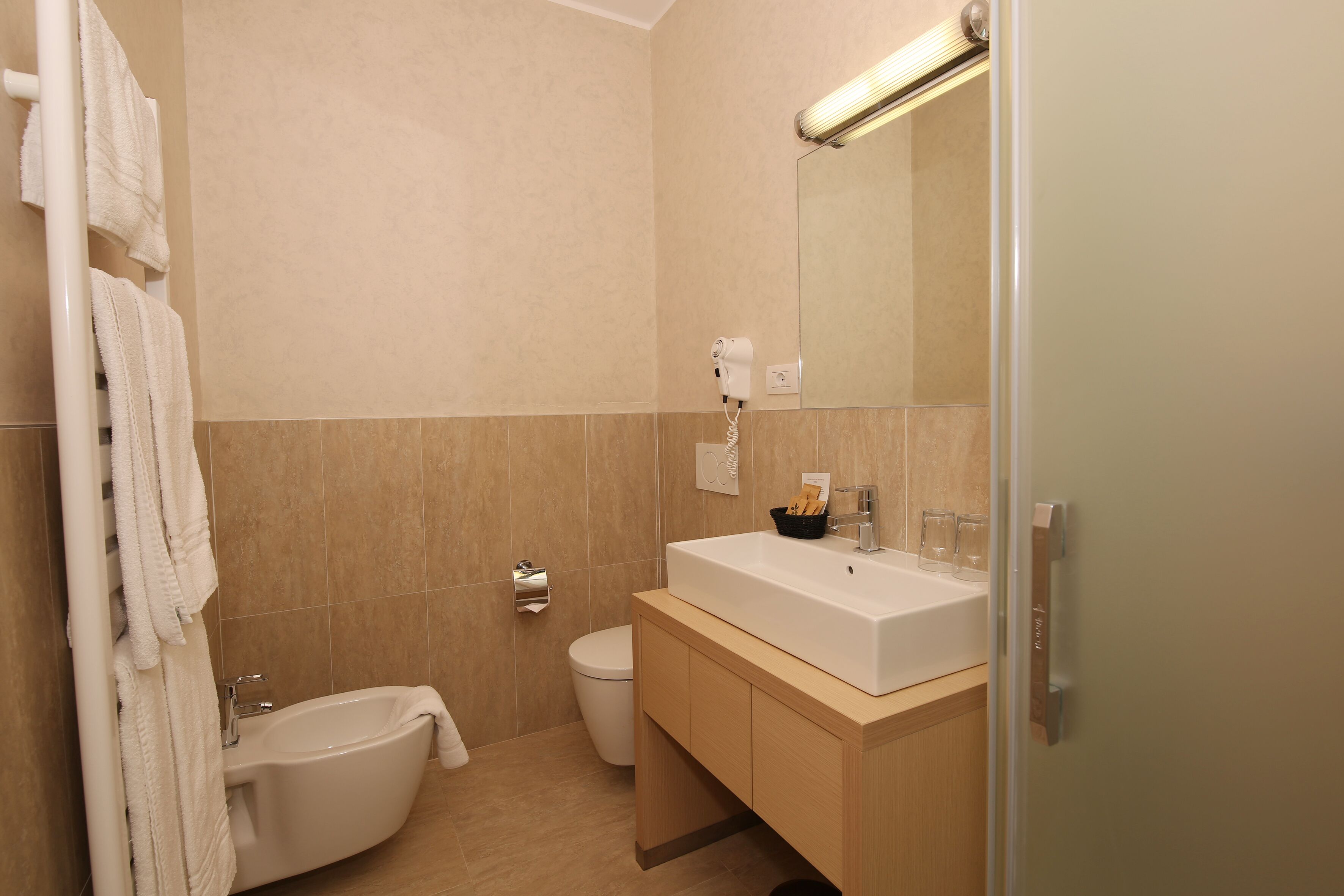 A modern bathroom with a bathtub, a sink, and a toilet.