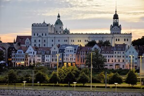 A hotel with a prominent tower and a large building with a green dome.