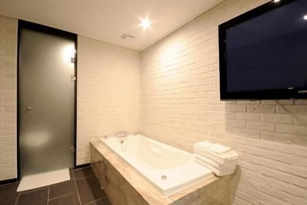 Bathroom | Designer toiletries, hair dryer, bathrobes, slippers