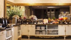 A buffet setup with a variety of food items, including fruits, pastries, and beverages. - The Cube Malioboro Hotel (Yogyakarta)