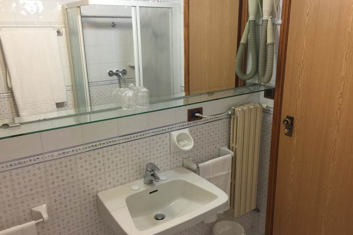 deep-soaking bathtub, rainfall showerhead, hair dryer, towels