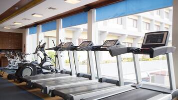 A gym with treadmills, stationary bikes, and ellipticals.