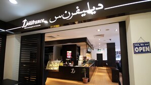 A café entrance with a sign reading "Défrance" and a "YES, We are OPEN" sign. - Badi'ah Hotel (Bandar Seri Begawan)