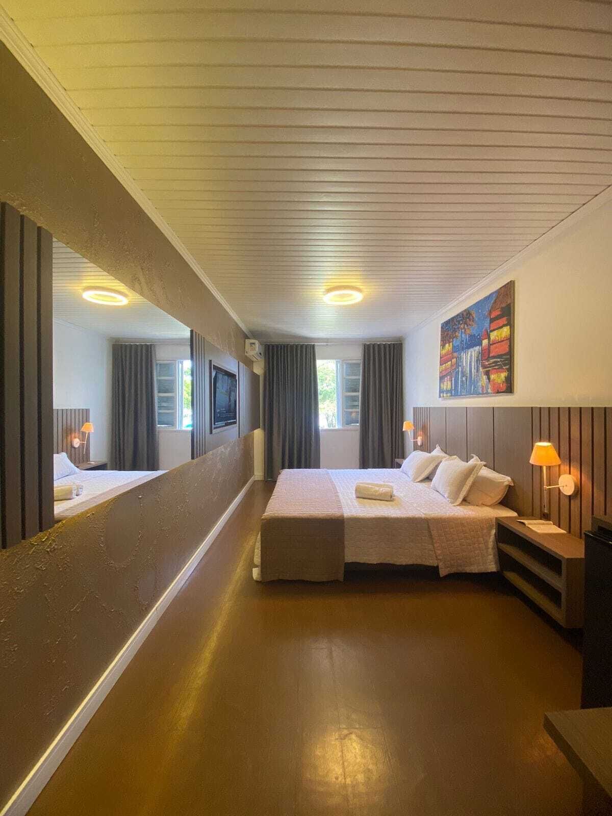 Habitación doble de lujo, vista parcial al océano | Minibar, caja de seguridad en la habitación y ropa de cama 
