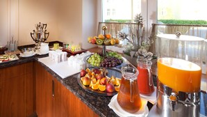 A breakfast buffet with fruits, juices, and a coffee station. - Hotel Reza (Frantiskovy Lazne)