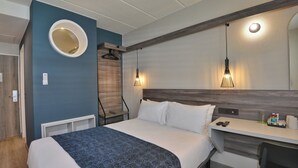 A hotel room with a bed, bedside table, and a mirror on the wall. - Road Lodge N1 City (Cape Town)