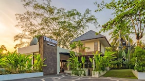 A modern building with a sign reading "THE EUBUD Restaurant & Bar" at sunset. - Labak River Hotel by EPS (Ubud)