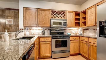 Suite, 2 Bedrooms | Private kitchen | Full-sized fridge, microwave, stovetop, dishwasher