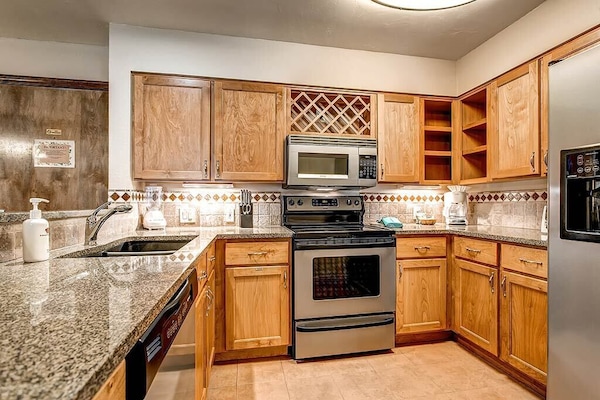 Suite, 2 Bedrooms | Private kitchen | Full-sized fridge, microwave, stovetop, dishwasher
