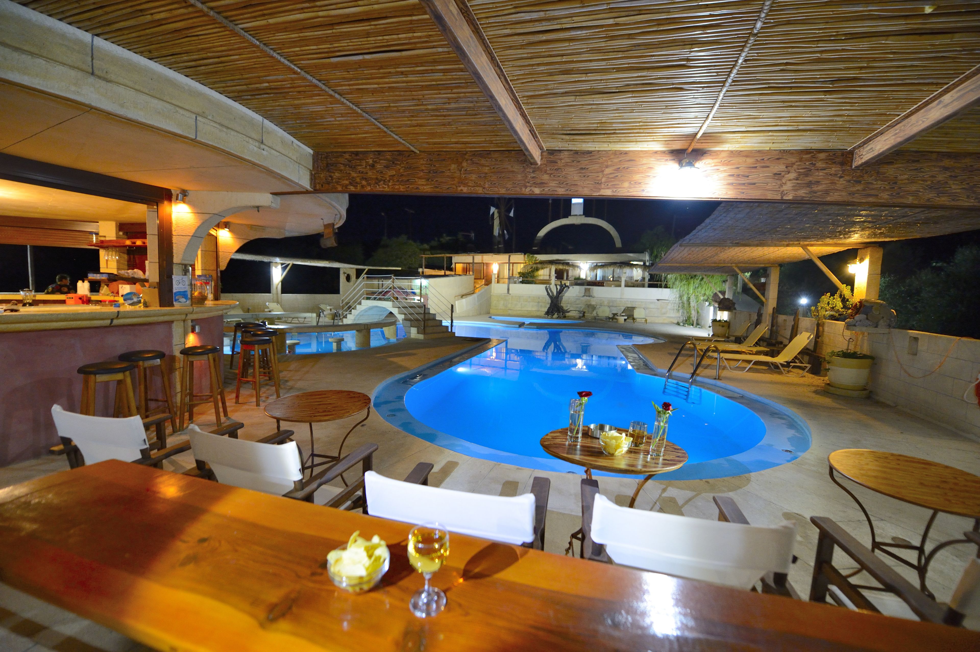 An outdoor pool area with a bar and seating.