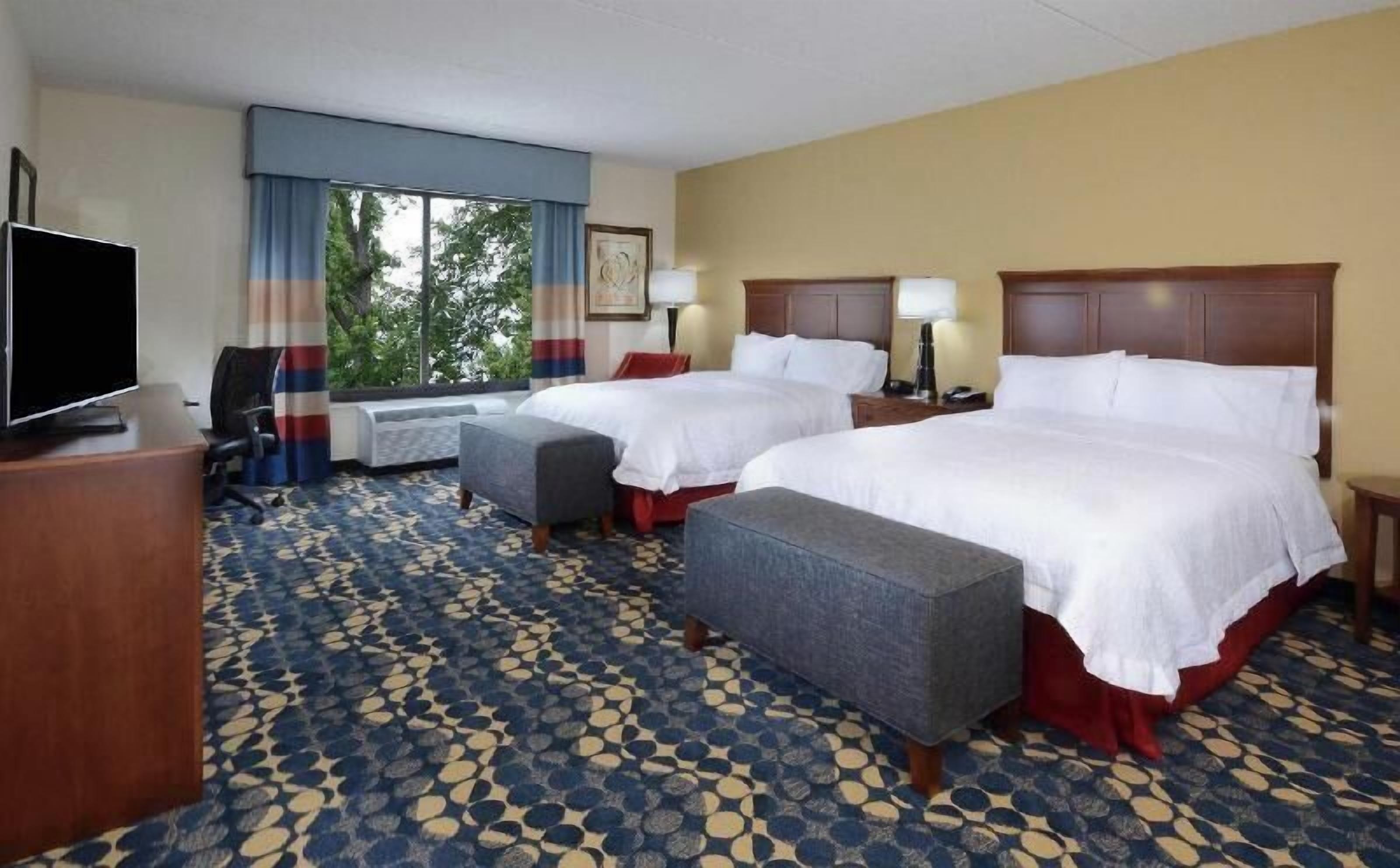 Premium bedding, desk, laptop workspace, blackout drapes