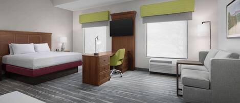 A hotel room with a bed, desk, chair, sofa, and large windows.