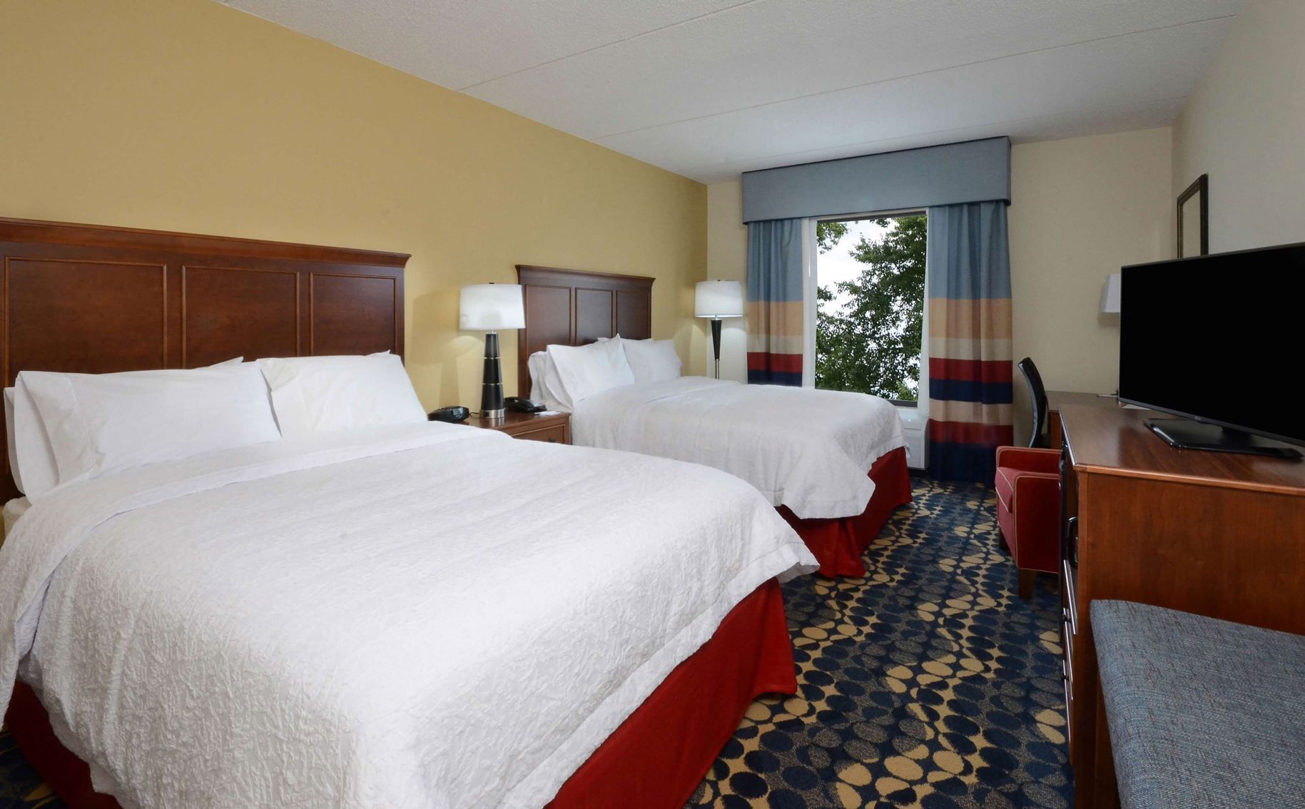 Premium bedding, desk, laptop workspace, blackout drapes