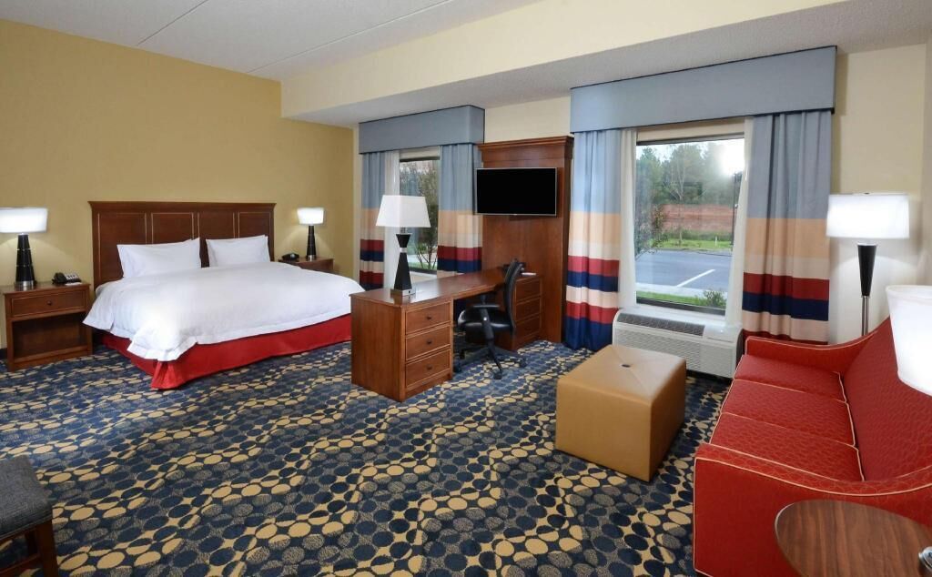 Premium bedding, desk, laptop workspace, blackout drapes