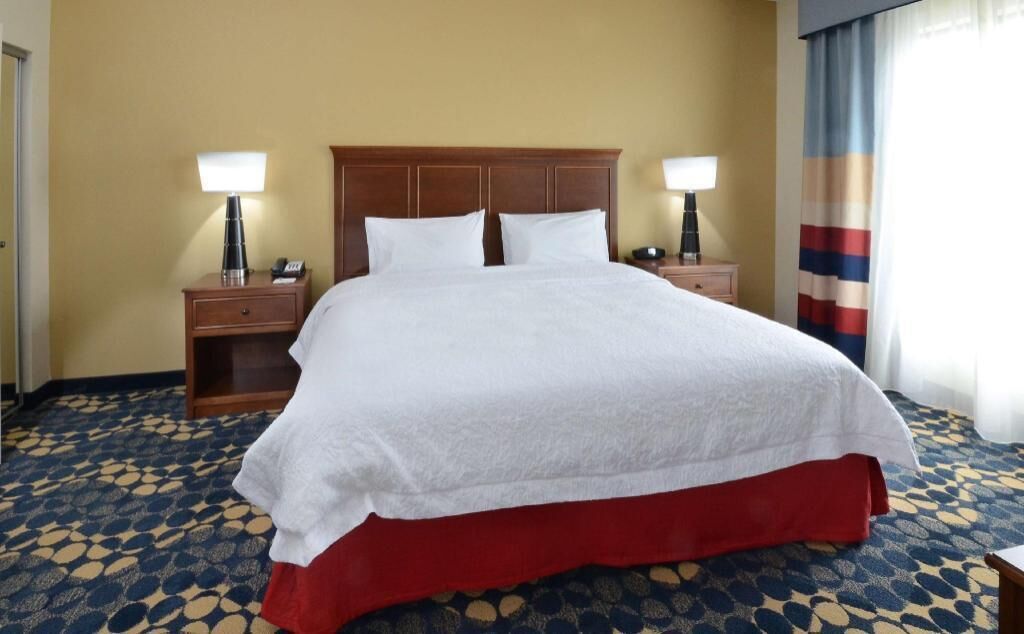 Premium bedding, desk, laptop workspace, blackout drapes