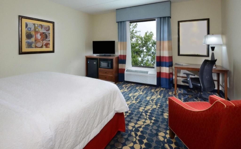Premium bedding, desk, laptop workspace, blackout drapes