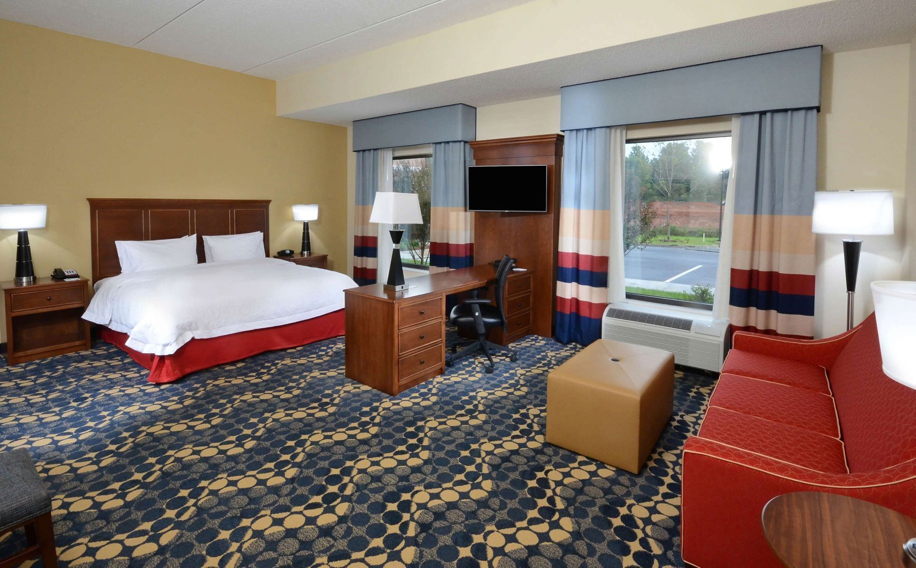Premium bedding, desk, laptop workspace, blackout drapes