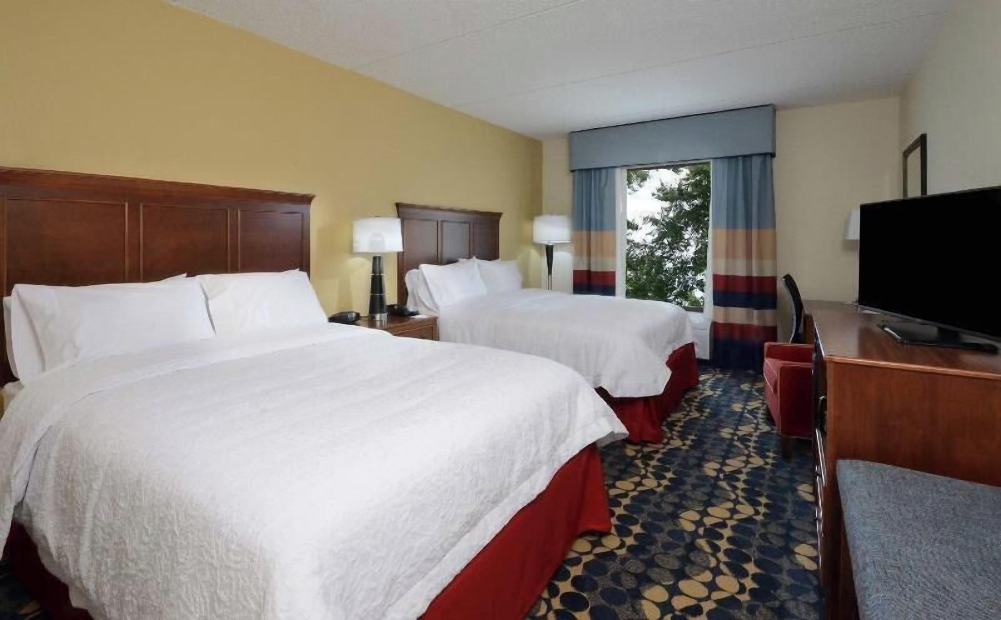 Premium bedding, desk, laptop workspace, blackout drapes